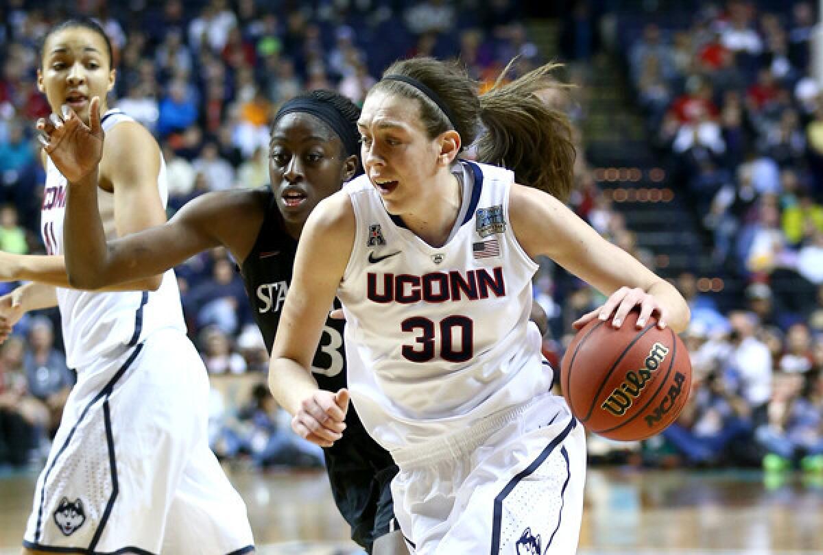 Connecticut forward Breanna Stewart drives past Stanford forward Chiney Ogwumike in the second half of their NCAA tournament semifinal on Sunday in Nashville, Tenn.