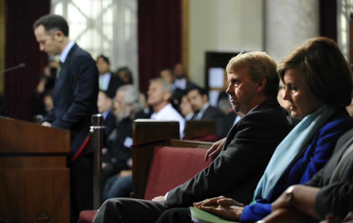 Michael Shull, general manager of the L.A. City Department of Recreation and Parks, listens to Rick Mueller, president of AEG Live North America, speak Wednesday during a meeting at L.A. City Hall about the Greek Theatre.