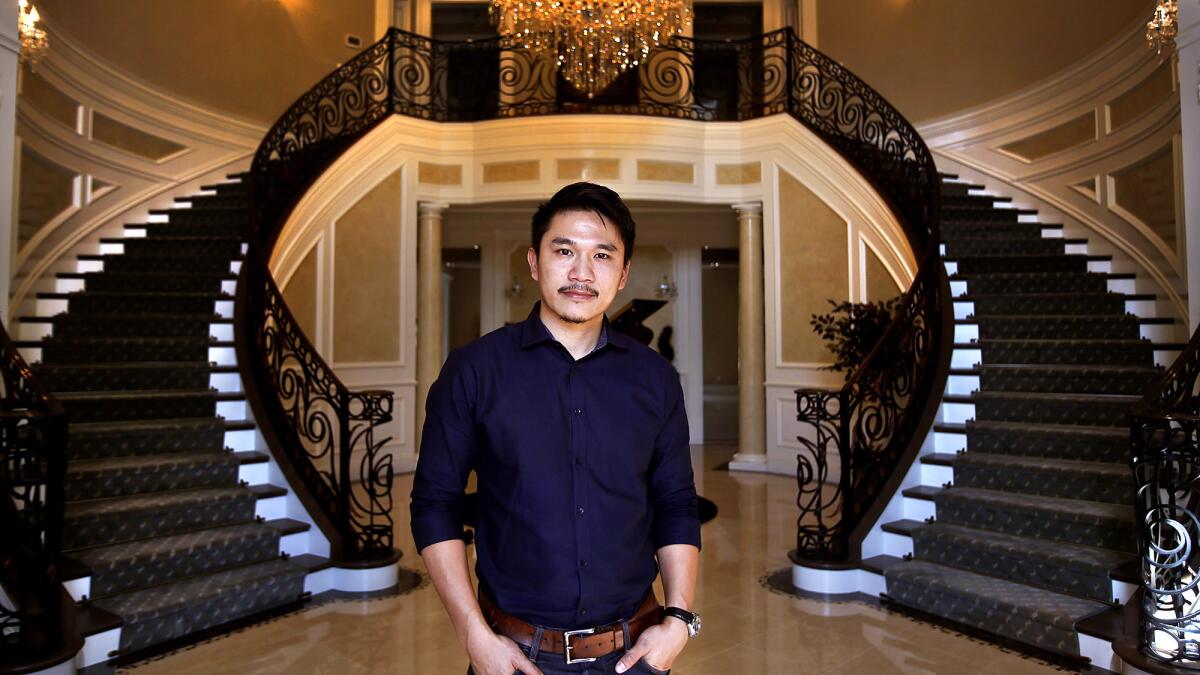 Philip Chan, principal designer at PDS Studio, stands inside an 11,000-square-foot home he worked on that is being offered for $6.99 million.