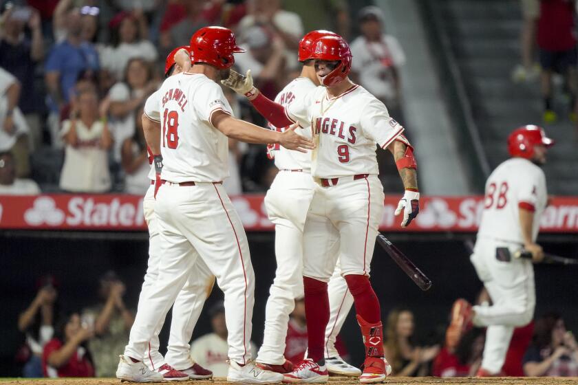 The Angels' Zach Neto celebrates with Nolan Schanuel after hitting a three-run home run during the seventh inning 