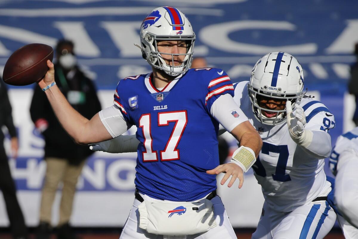 Buffalo Bills quarterback Josh Allen throws a pass in front of  Indianapolis Colts defensive end Al-Quadin Muhammad.