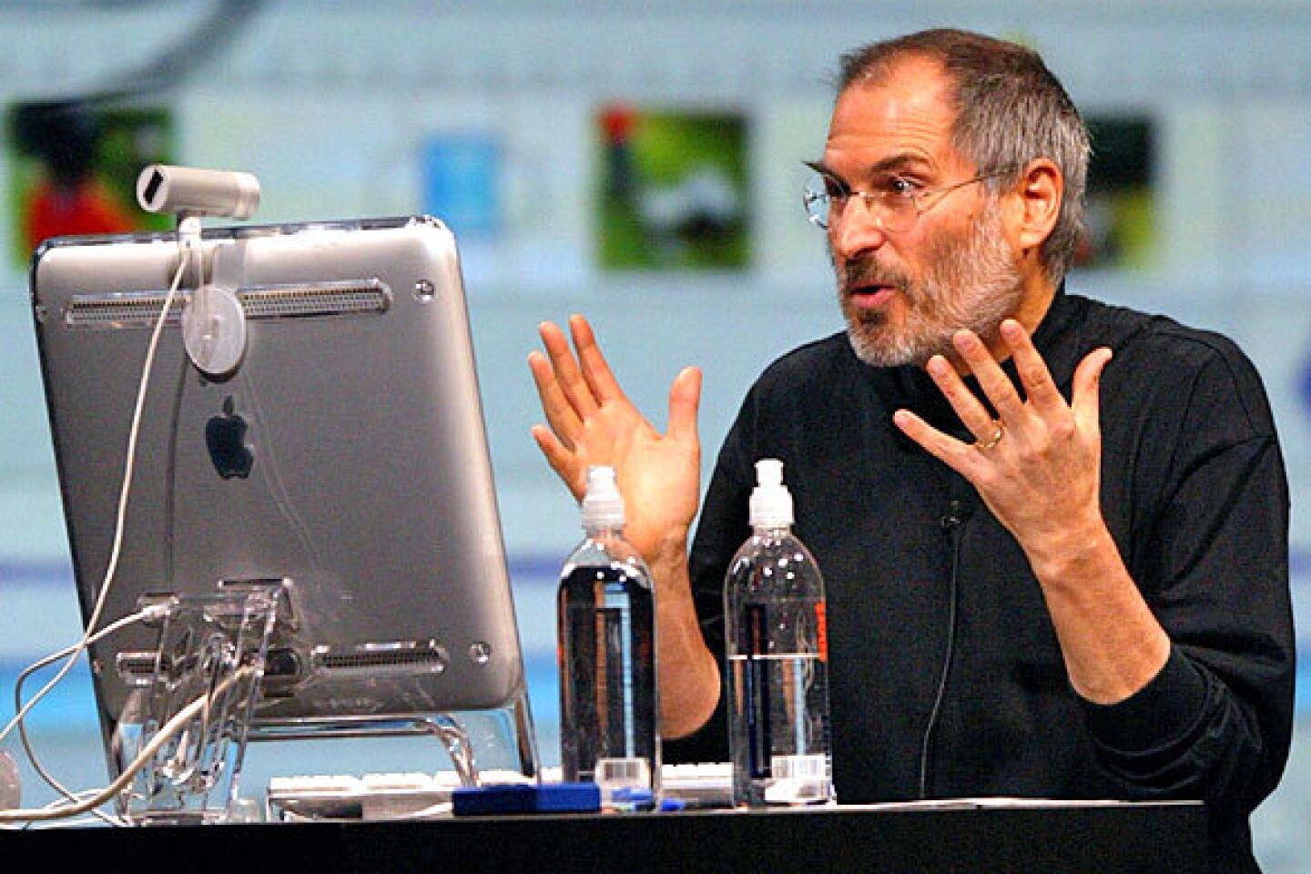 Jobs gestures as he delivers a keynote address at the 2004 MacWorld conference. Jobs announced several new products including the new iLife 4 software and the iPod Mini.