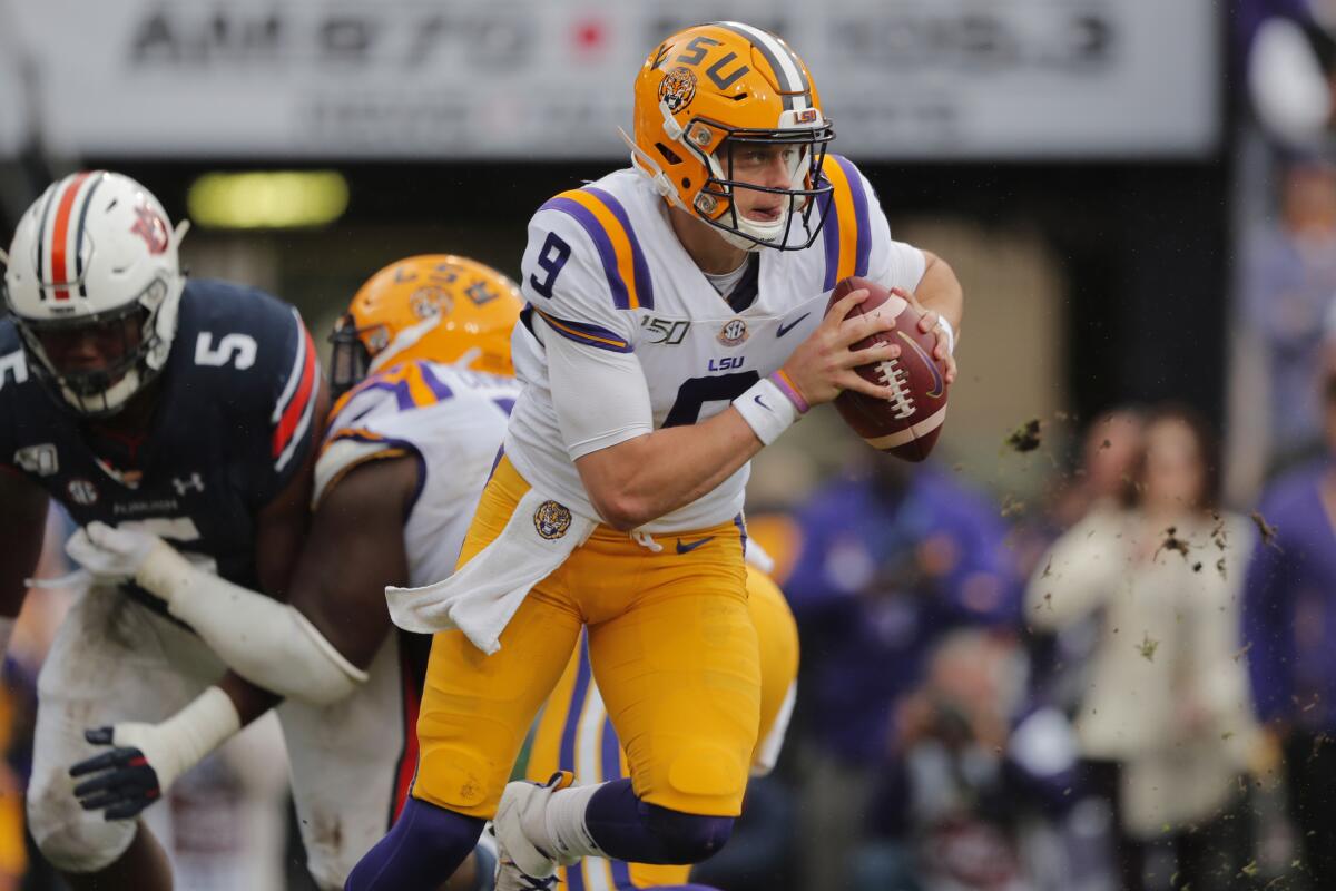 LSU quarterback Joe Burrow scrambles in the first half against Auburn on Saturday.