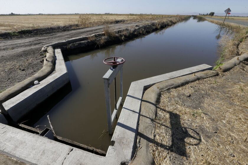 Water flows down a canal near Byron, Calif. A new poll finds Californians more concerned about the drought than any other issue.