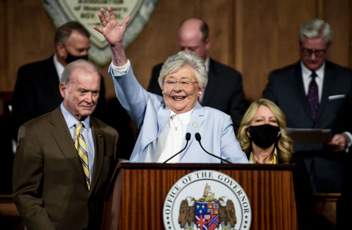 FILE - Alabama Gov. Kay Ivey waves as she arrives to deliver her State of the State address at the State Capitol Building in Montgomery, Ala., Jan. 11, 2022. Ninth grader Harleigh Walker, 15, spent her spring break trying unsuccessfully to persuade members of the state House and Senate to reject legislation banning gender-affirming medications for transgender kids like her under 19. On Thursday, April 7, Alabama lawmakers passed the measure, and Gov. Ivey signed it into law on Friday. (Mickey Welsh/The Montgomery Advertiser via AP, File)
