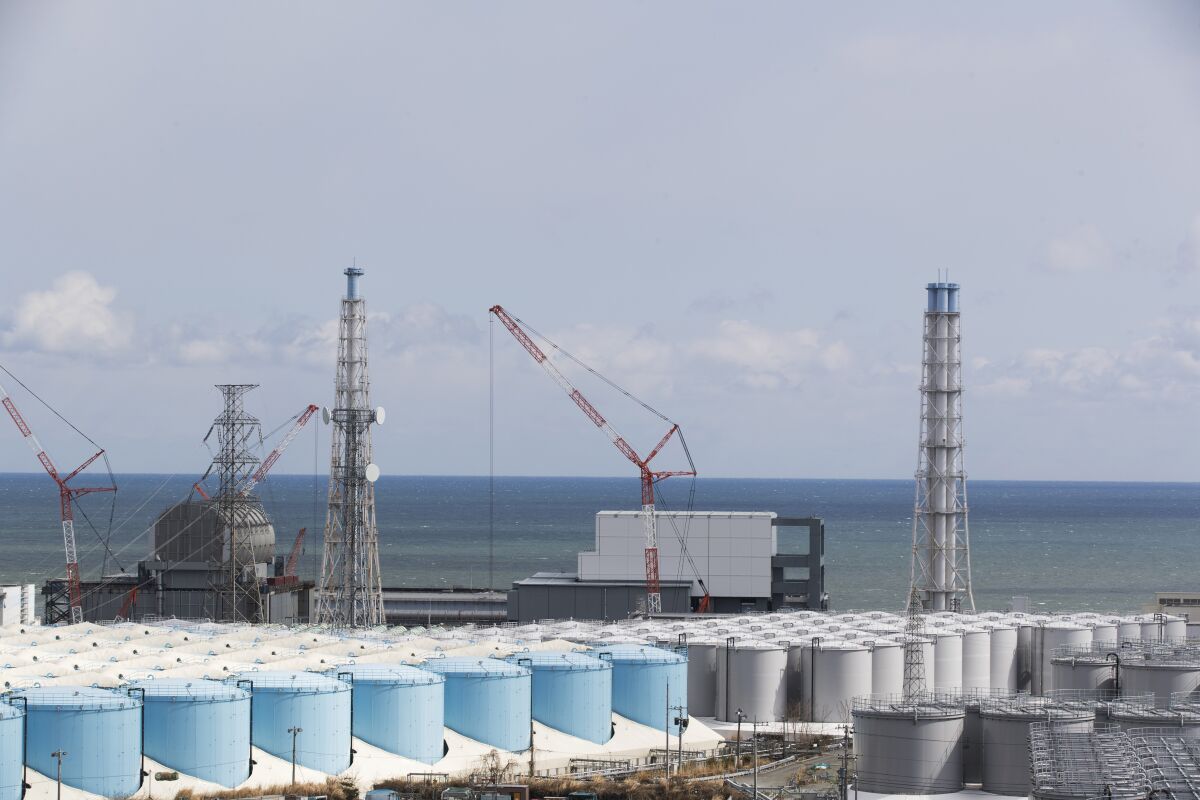 FILE - The Pacific Ocean looks over nuclear reactor units of No. 3, left, and 4 at the Fukushima Daiichi nuclear power plant in Okuma town, Fukushima prefecture, northeastern Japan on Feb. 27, 2021. A team from the U.N. nuclear agency arrived in Japan on Monday, Nov. 15, 2021 to assess preparations for the release into the ocean of treated radioactive water from the wrecked Fukushima nuclear plant. (AP Photo/Hiro Komae, File)