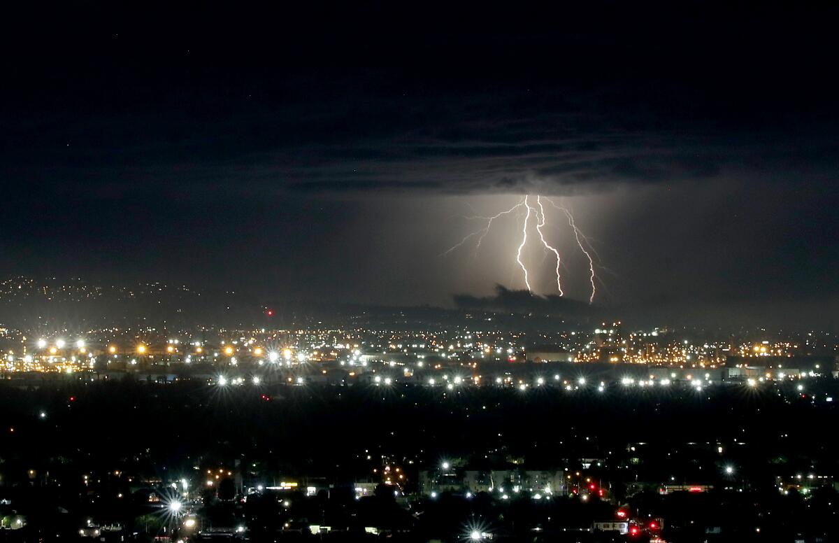 Lightning flares from the clouds above the South Bay as a storm moves across the Los Angeles Basin.