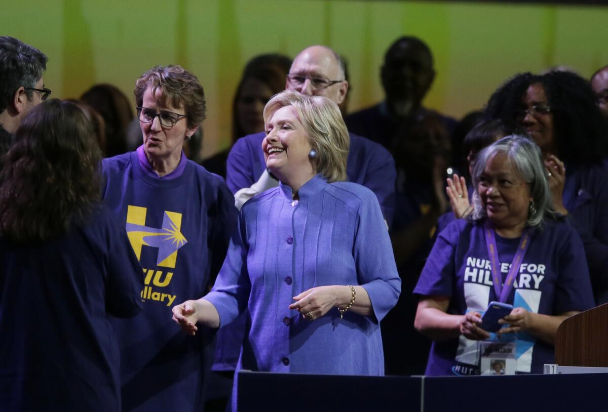 Hillary Clinton meets with SEIU members at the union's May convention in Detroit. At left is union President Mary Kay Henry.