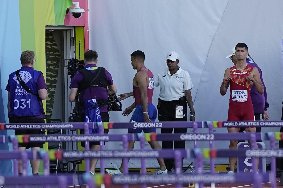 Devon Allen leaves the track after being disqualified from the men's 110-meter hurdles Sunday.