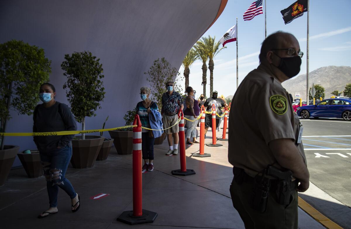 Crowds line up to enter Morongo Casino in Cabazon, Friday afternoon. Patrons are required to wear masks and to have their temperature taken upon entering. The casino reached full capacity within three hours of opening.