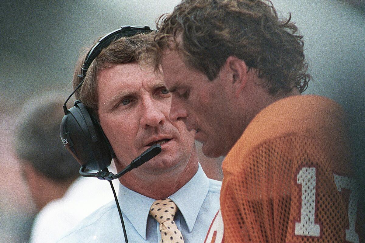 Tampa Bay Buccaneers coach Ray Perkins talks with quarterback Steve DeBerg on the sidelines.