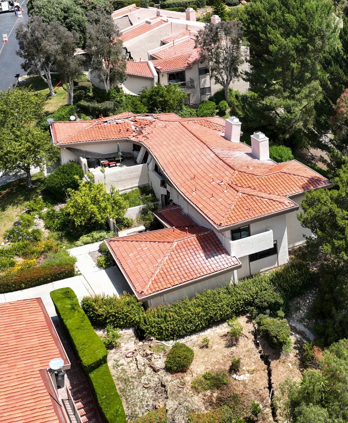 An aerial view of homes with red tiled roofs. 