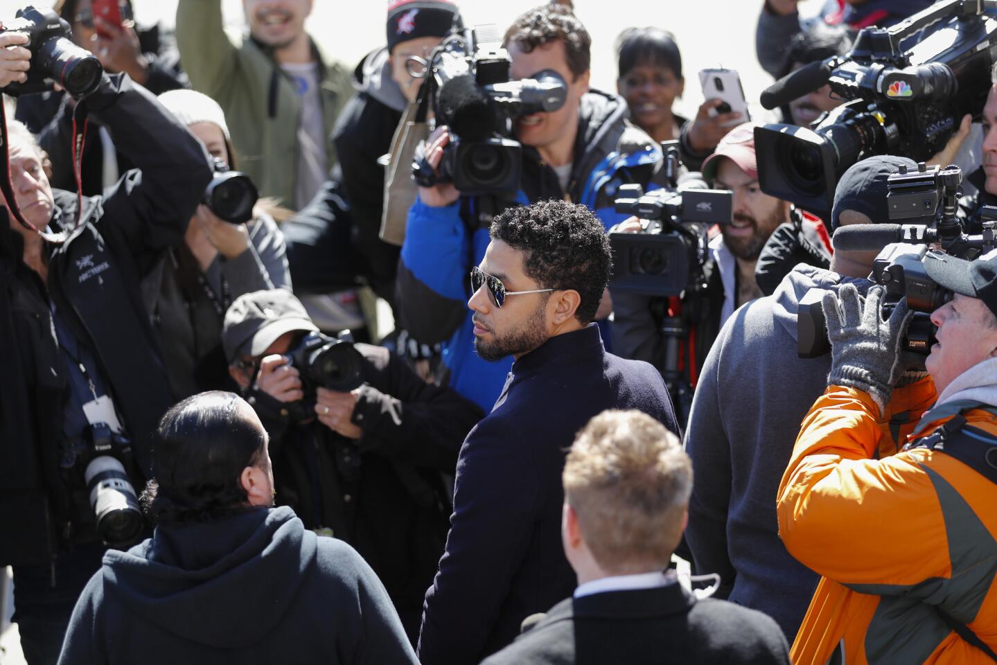 Jussie Smollett is surrounded by the media as he waits for his car to pick him up after all charges against him are dropped at the Leighton Criminal Court Building in Chicago on March 26, 2019.