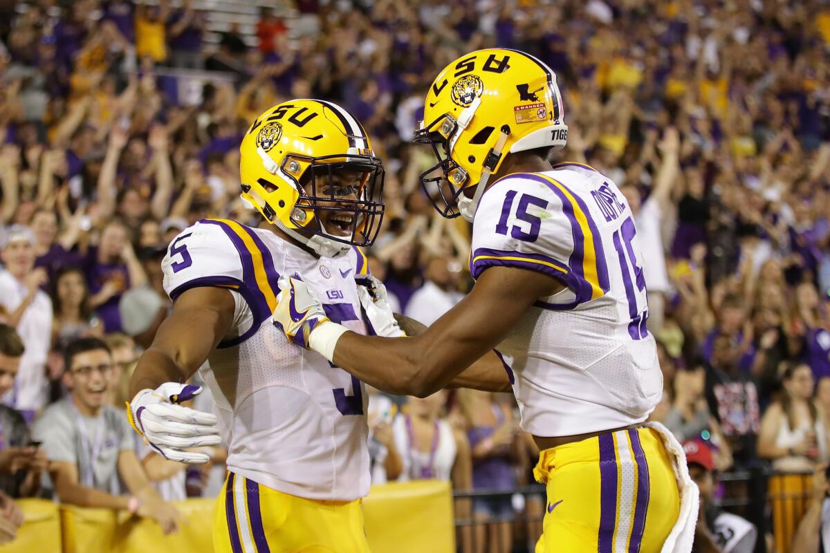 LSU running back Derrius Guice (5) celebrates with receiver Malachi Dupre after Guice scored a touchdown against Missouri on Oct. 1.
