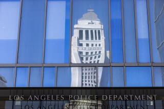 Los Angeles, CA - September 26: Los Angeles City Hall tower is reflected above the entrance to LAPD Headquarters in downtown Los Angeles on Tuesday, Sept. 26, 2023 in Los Angeles, CA. (Brian van der Brug / Los Angeles Times)