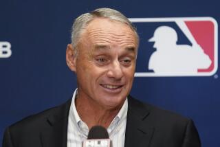 Major League Baseball Commissioner Rob Manfred speaks to reporters following an owners' meeting.