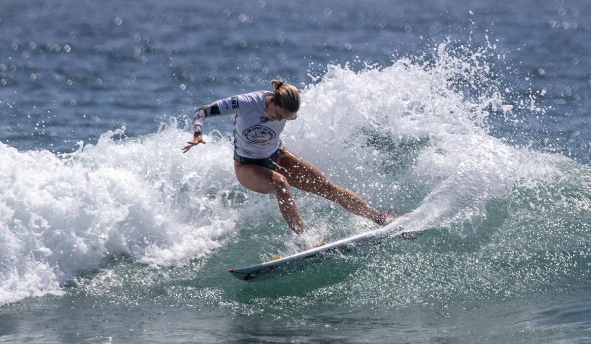 Surfer Bethany Hamilton of Kauai, Hawaii, does a slashing turn as she competes at the U.S. Open of Surfing in Huntington Beach.