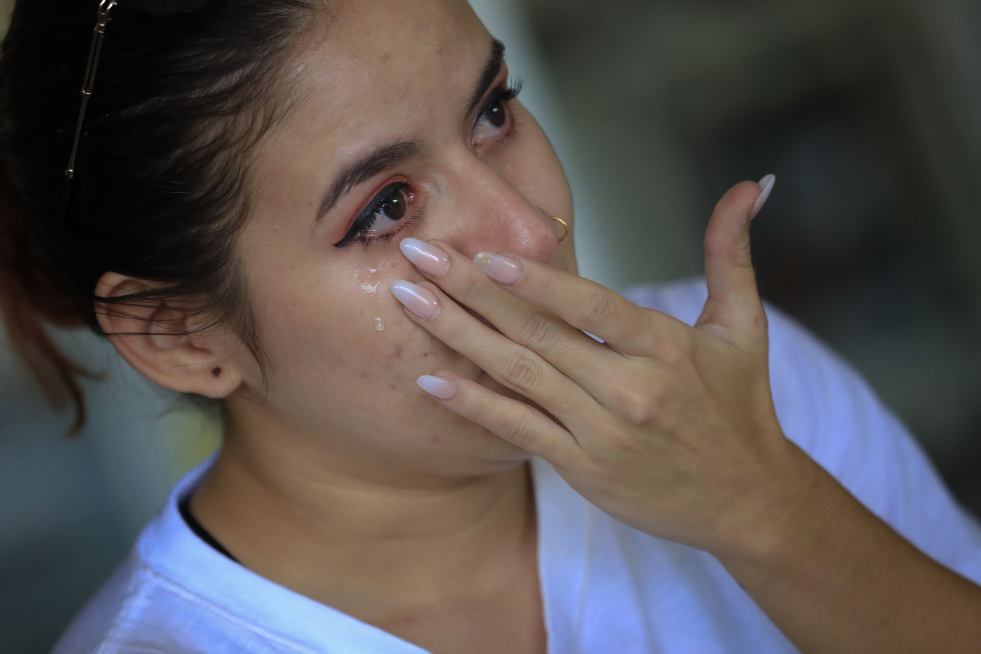Jency Lopez, known as Bgirl Jency Fresh, wipes a tear from her eye as she talks about the death of her mentor.
