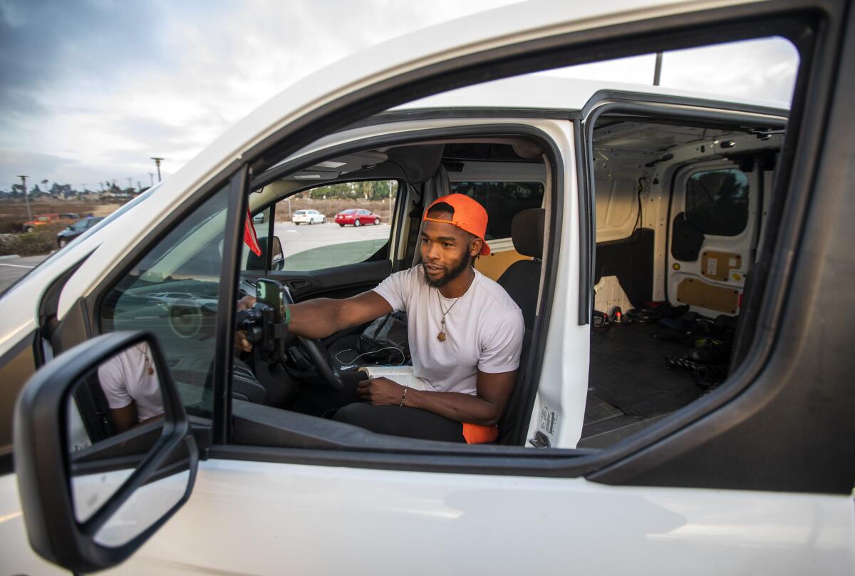 Oliver James in the driver's seat of his cargo van