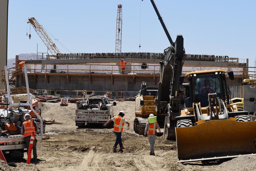 San Bernardino, CA - August 20: Workers continue construction progress on the Mt. Vernon Bridge Replacement Project, near the Mitla Cafe in San Bernardino. It's an 86-year-old Mexican restaurant on what was Route 66 that has had a hard time because of a huge construction project nearby. Photo taken Tuesday, Aug. 20, 2024. (Allen J. Schaben / Los Angeles Times)