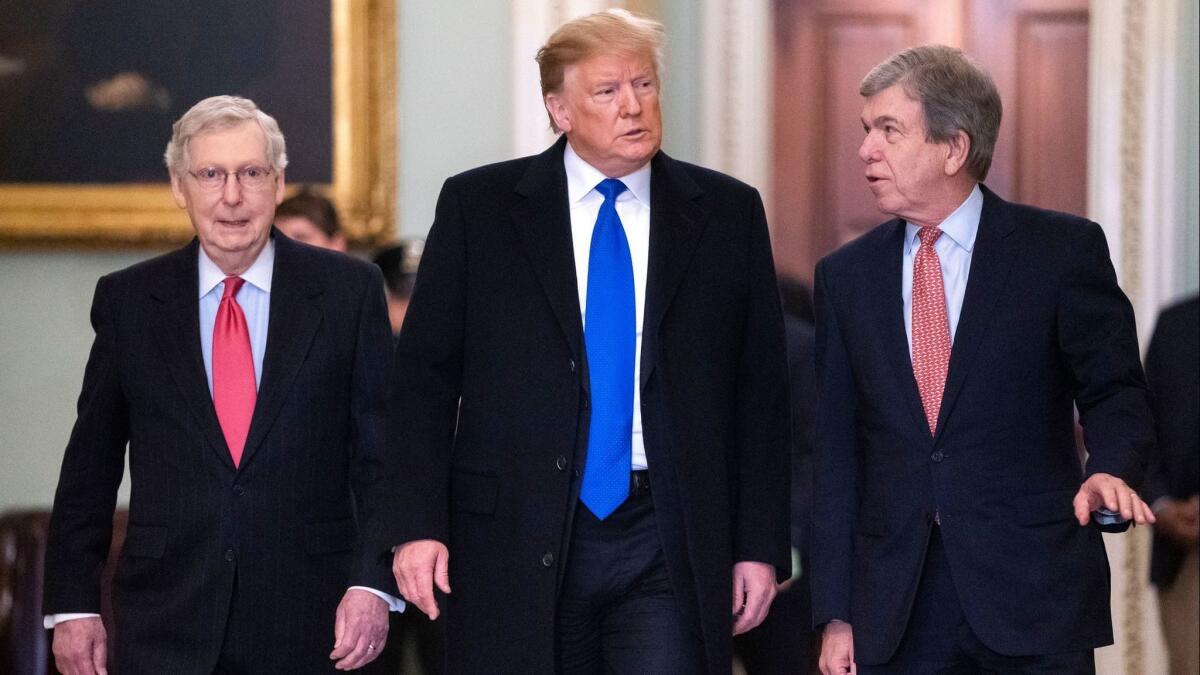 President Trump, Senate Majority Leader Mitch McConnell, and Senator Roy Blunt walk to a meeting with Senate Republicans in Washington on March 26.