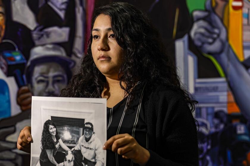 LOS ANGELES, CA, APRIL 06, 2019 --- Melissa Castro holds a photo of her husband Jos? Ibarra Bucio shown chained to the hospital bed. Bucio, 27, a detainee at the Adelanto immigration detention center, died weeks after he was taken to a local hospital. (Irfan Khan / Los Angeles Times)