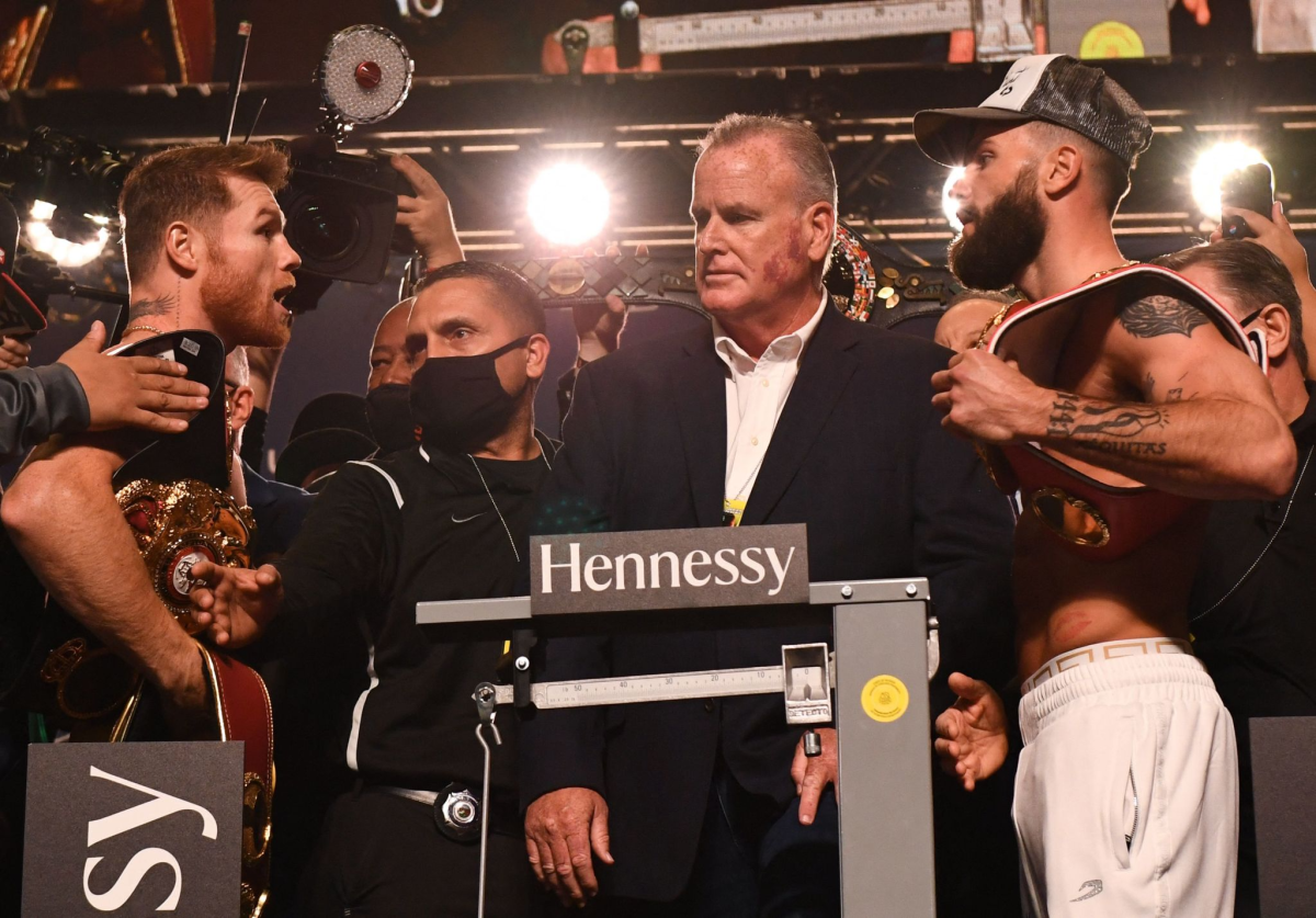 Canelo Alvarez, left, exchanges words with Caleb Plant during their weigh-in at the MGM Grand Garden Arena on Friday.