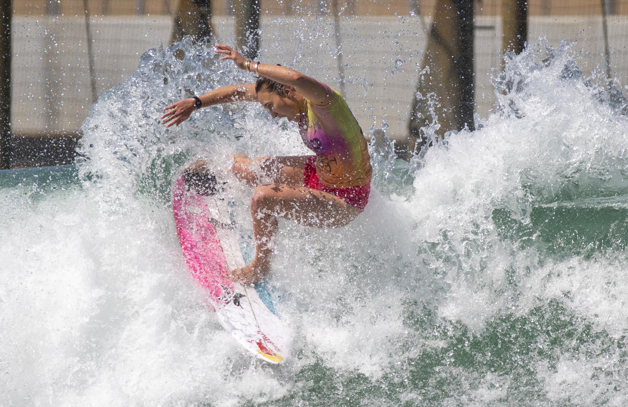 Carissa Moore does a slashing turn off of a wave