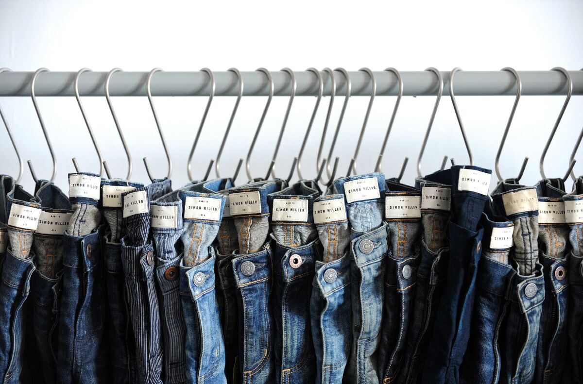 Denim jeans hang inside Simon Miller's studio in downtown Los Angeles on Monday, October 20, 2014. The two are CFDA/Vogue Fashion Fund finalists.