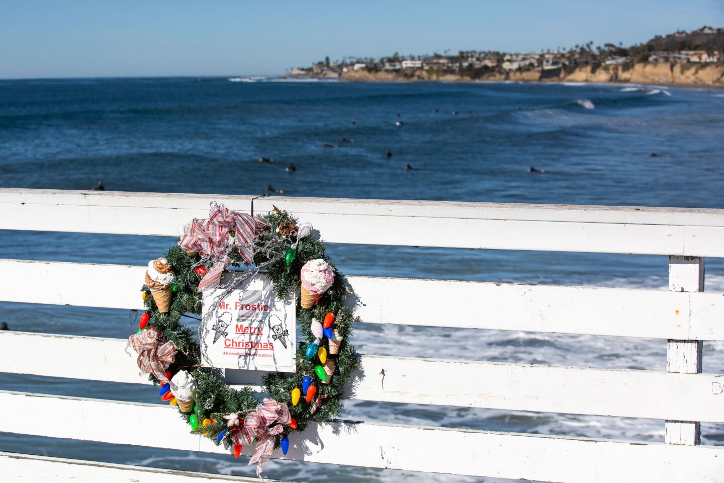 A Mr. Frostie wreath is one of more than 30 Christmas wreaths lining Crystal Pier in Pacific Beach. Discover Pacific Beach, the business improvement district, hopes the wreaths will provide local businesses with more exposure.