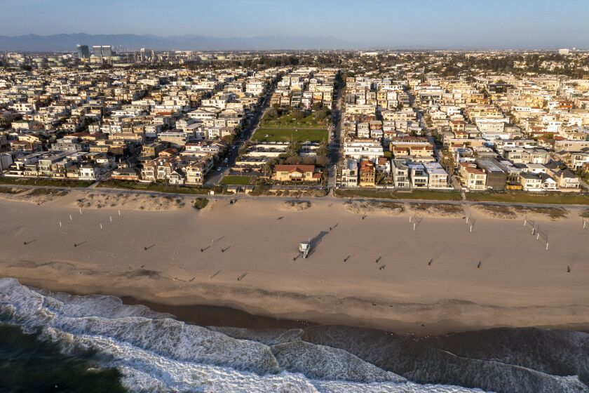 Manhattan Beach, CA - March 24: An aerial view of Bruce's Beach at sunset. Los Angeles County is trying to give the land back to the Bruce family, a Black family that was pushed off Bruce's Beach a century ago by Manhattan Beach. Bruce's Beach was one of the most prominent Black-owned resorts by the sea.The Bruce family used to have a resort right on the strand where the Los Angeles County Lifeguard Division office is and was popular with Black beachgoers. The Bruce's Beach plaque is at the top of the hill, but the actual Bruce property is the lifeguard building at the bottom of the hill, on the Strand at Bruce's Beach between 26th Street and 27th Street on Wednesday, March 24, 2021 in Manhattan Beach, CA. (Allen J. Schaben / Los Angeles Times)
