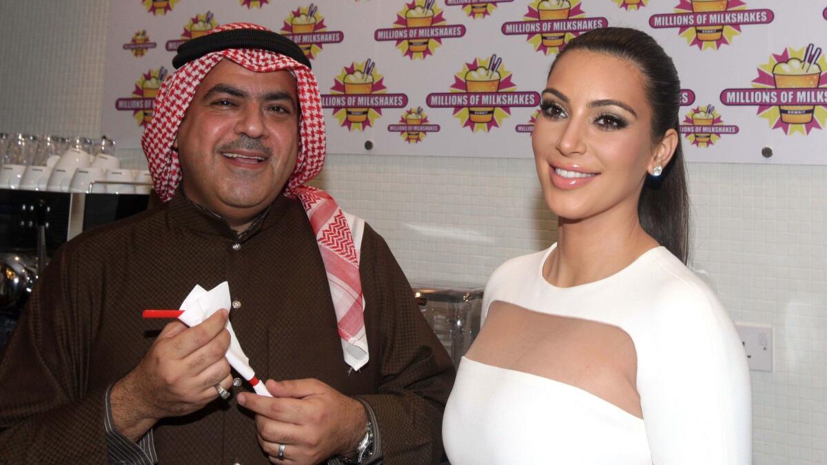 Kim Kardashian models what not to do as she celebrates a new burger joint, "Millions of Milkshakes," in a Kuwaiti mall on November 29, 2012.