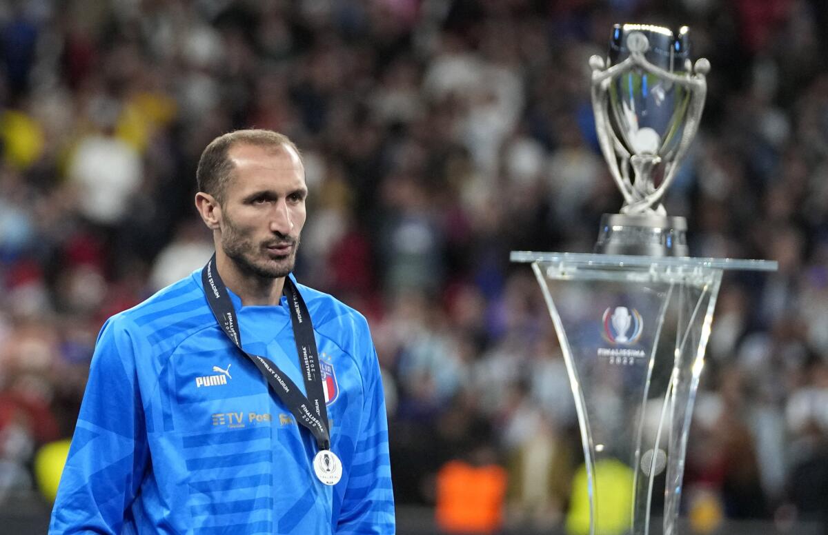 Italy's Giorgio Chiellini walks past the trophy at the end of the Finalissima soccer match 