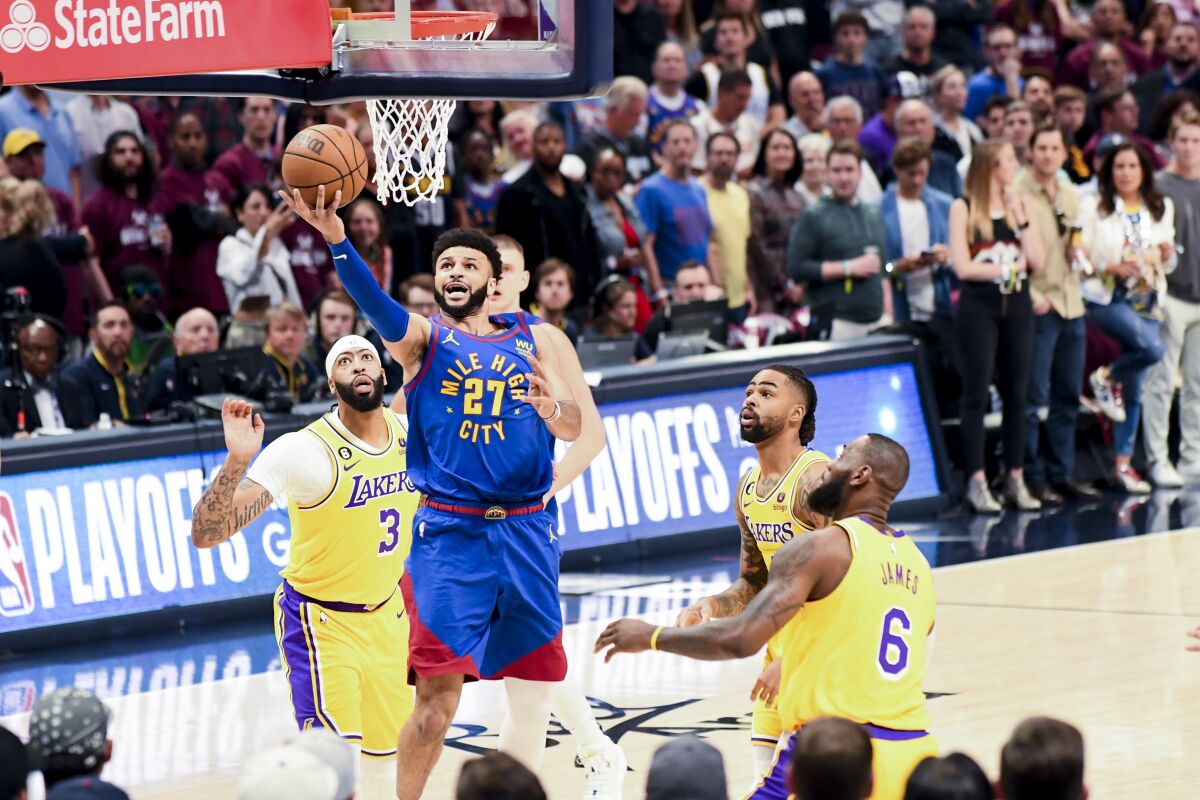 Nuggets guard Jamal Murray, center, scores on a layup against the Lakers early in Game 1.