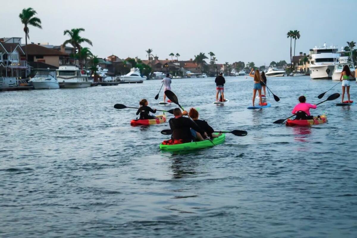 A group kayaks in Huntington Beach.