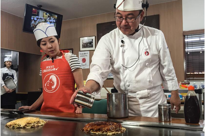 Yoshihiro Ueuchi teaches visitors to Hiroshima's Wood Egg how to make okonomiyaki.