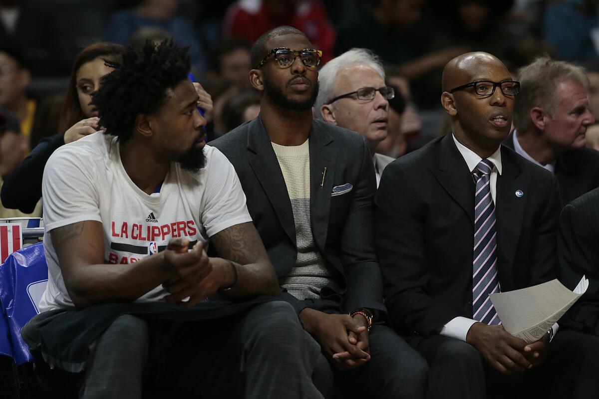 Chris Paul watches from the bench in street clothes as the Clippers play Indiana on Wednesday.