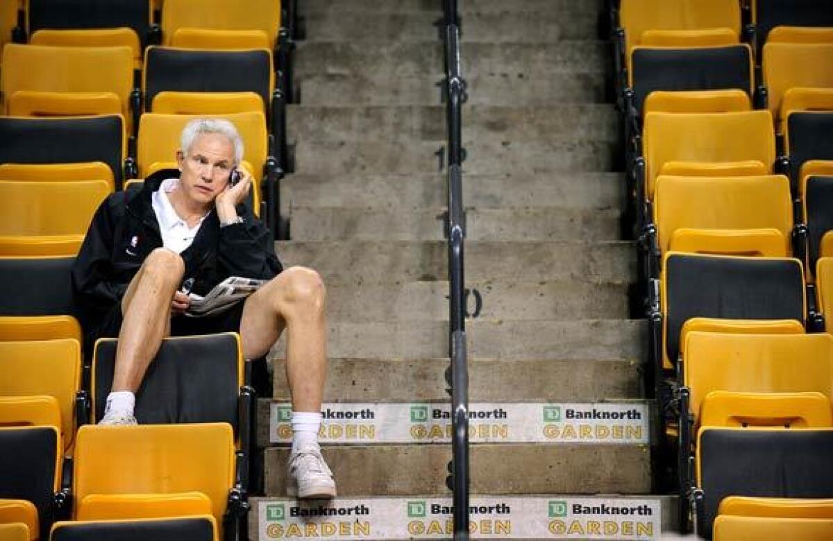 Lakers General Manager Mitch Kupchak on the phone during a 2008 practice at TD Garden in Boston.