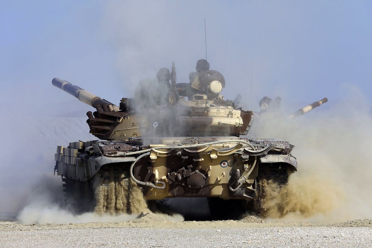 In this photo released by the official website of the Iranian Army on Sunday, Nov. 7, 2021, a tank moves during a maneuver in a coastal area, of southeastern Iran. Iran's military began its annual war games near the Gulf of Oman, Sunday, less than a month before upcoming nuclear talks with the West. (Iranian Army via AP)