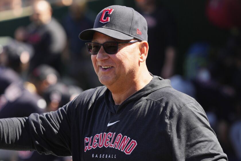 Cleveland Guardians manager Terry Francona smiles as he stands in the dugout prior to a spring training baseball game against the Cincinnati Reds, Saturday, Feb. 25, 2023. (AP Photo/Ross D. Franklin)