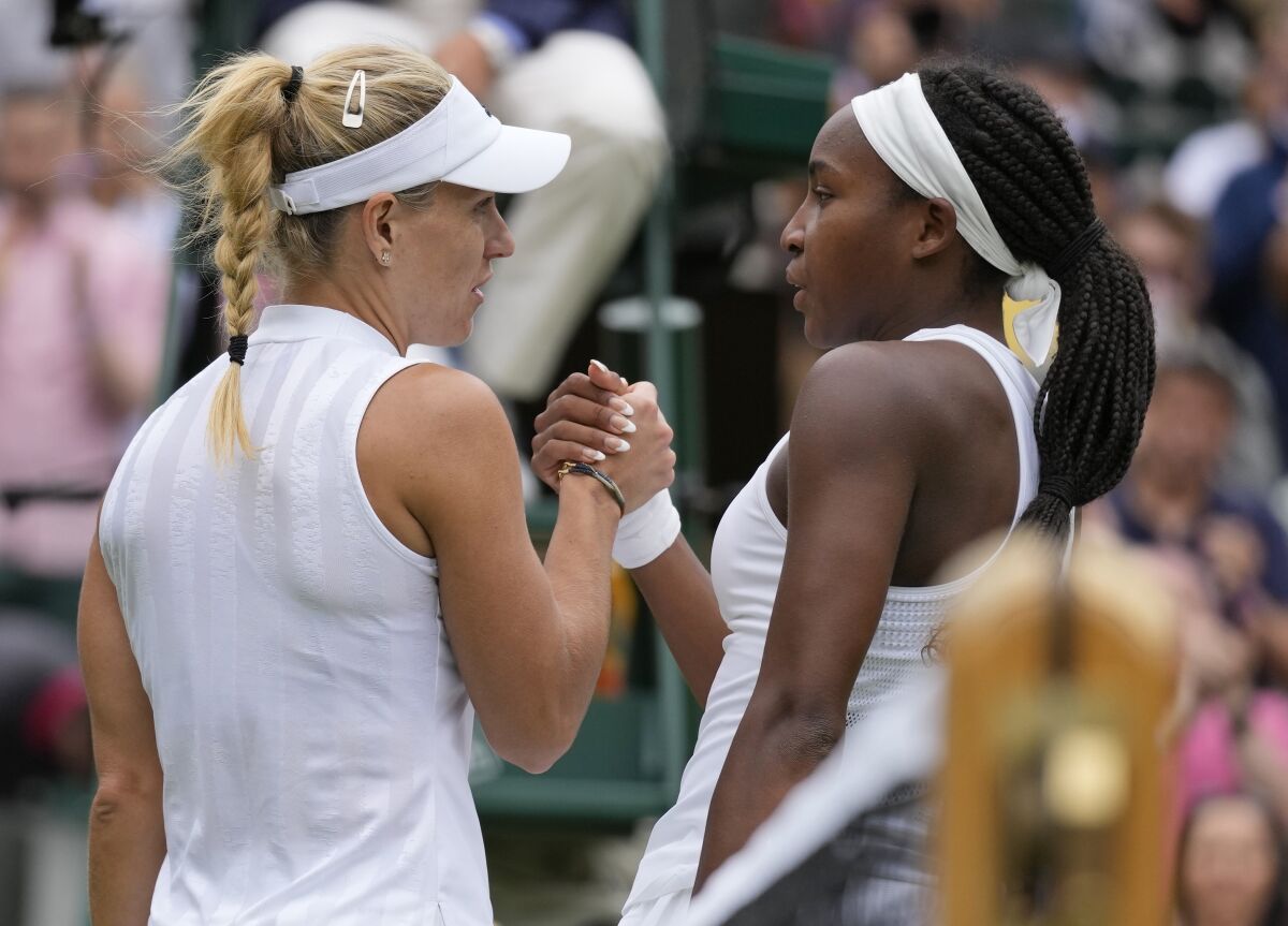 Angelique Kerber grasps Coco Gauff hand courtside