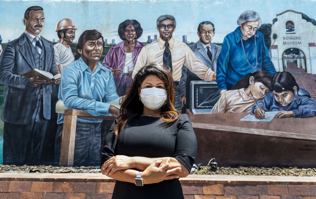 Former Santa Ana city councilwoman Michele Martinez stands in front of a downtown mural.