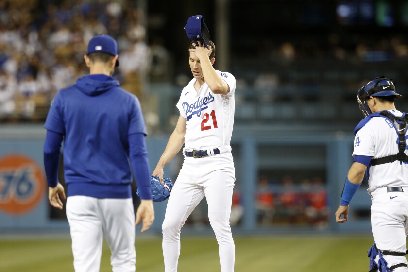 Dodgers throwing coach Mark Prior, left, visits starting pitcher Walker Buehler on the mound in the fourth inning on Friday.