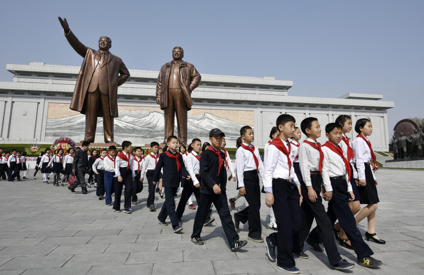 Children leave after paying respect to former leaders Kim Il-sung, left, and Kim Jong-il at Mansu Hill in Pyongyang on April 15.