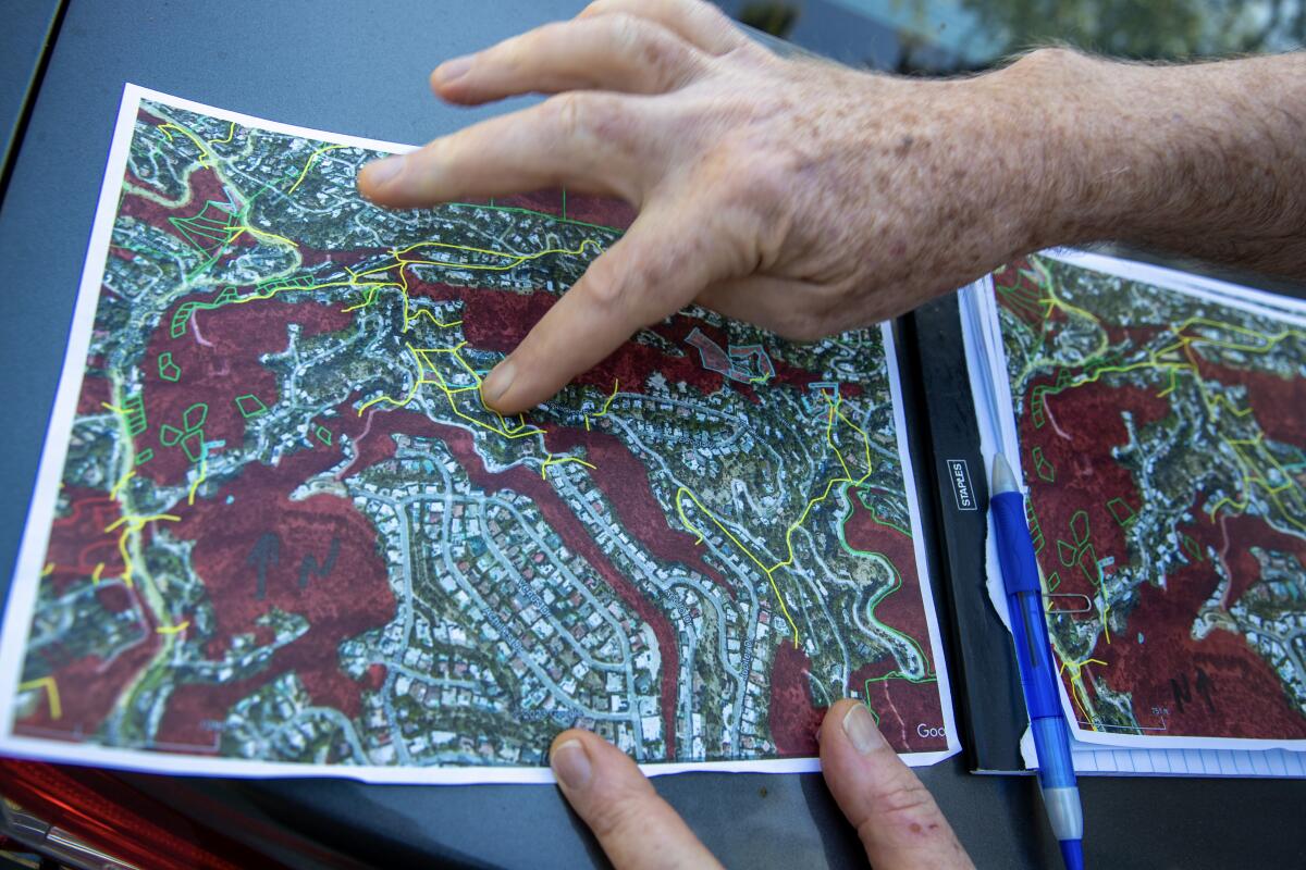 A person points to a map.