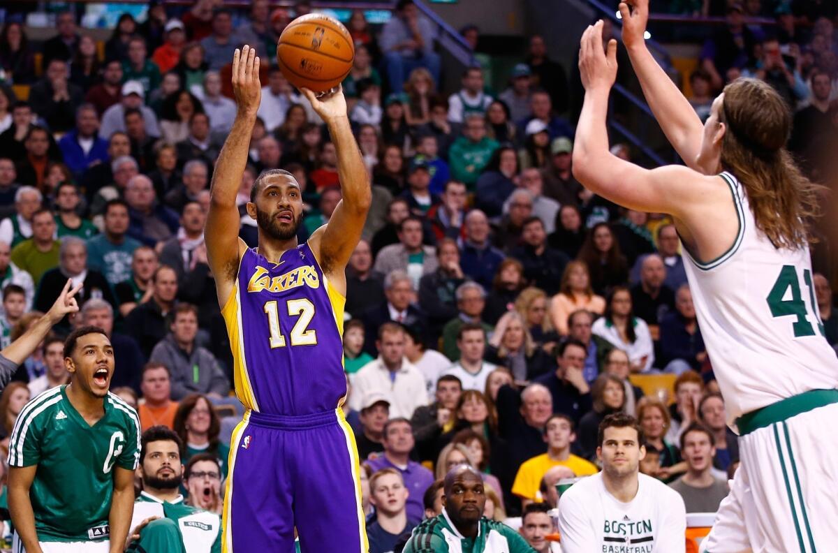 Point guard Kendall Marshall releases a three-point shot over Celtics forward Kelly Olynyk that was the finishing touch on a run that brought the Lakers from eight points down to a 105-104 lead.