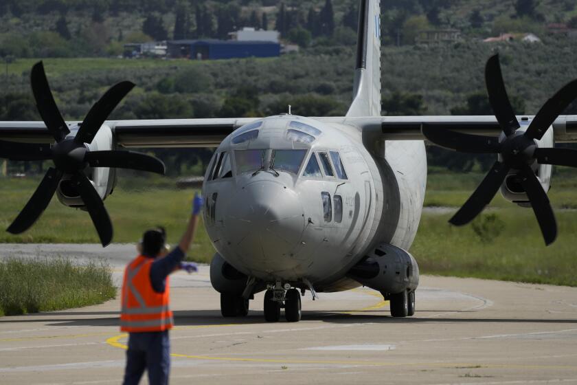 A military plane carrying evacuees from Sudan arrive at Tanagra air base, north of Athens on Wednesday, April 26, 2023. Sixteen Greeks and one Cypriot arrived in Greece after being evacuated from Sudan. (AP Photo/Thanassis Stavrakis)