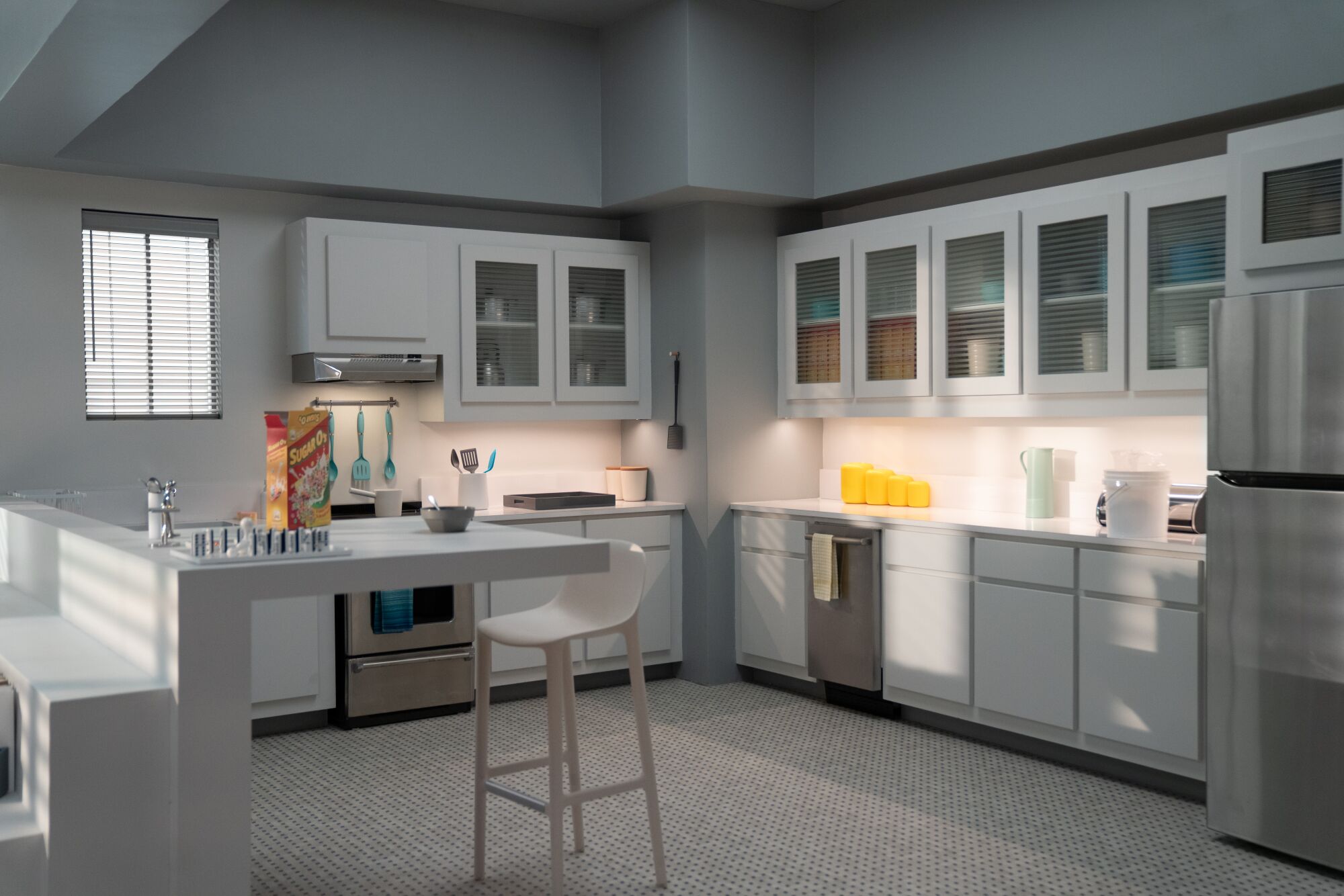 An apartment kitchen with one bar stool