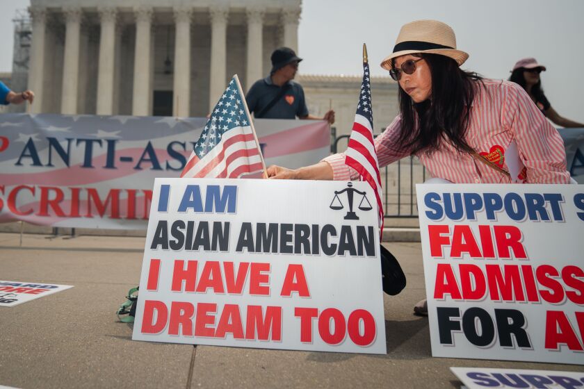 People with the Asian American Coalition for Education rally outside of the Supreme Court 