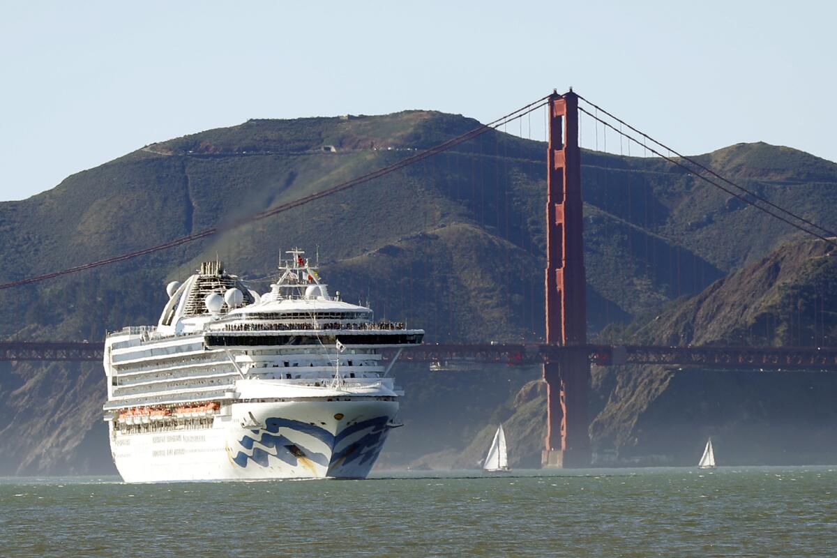 The Grand Princess on Feb. 11 passed by the Golden Gate Bridge on its arrival in San Francisco from Hawaii. The ship, on which 21 crew members and passengers tested positive for the coronavirus, was allowed to dock in Oakland on Monday.